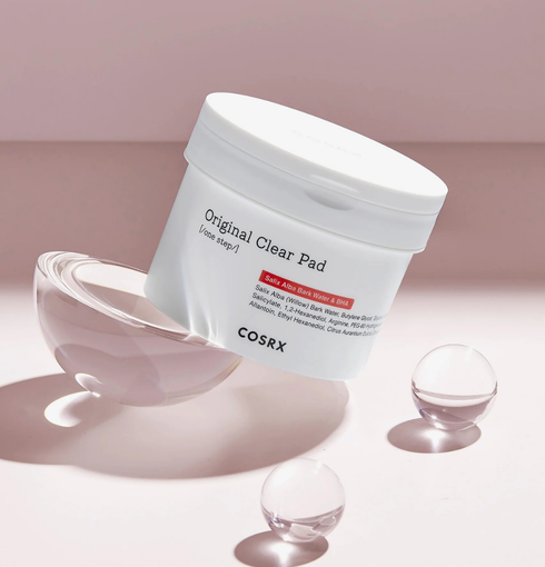 COSRX One Step Original Clear Pad - jar on pink background with glass spheres