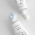 DR. ALTHEA 147 Barrier Cream - deux tubes avec de la crème blanche et bleu clair sur un fond gris épuré
